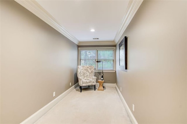 sitting room with carpet floors and ornamental molding