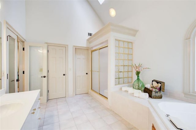 bathroom with vanity, high vaulted ceiling, a shower with door, and tile patterned flooring