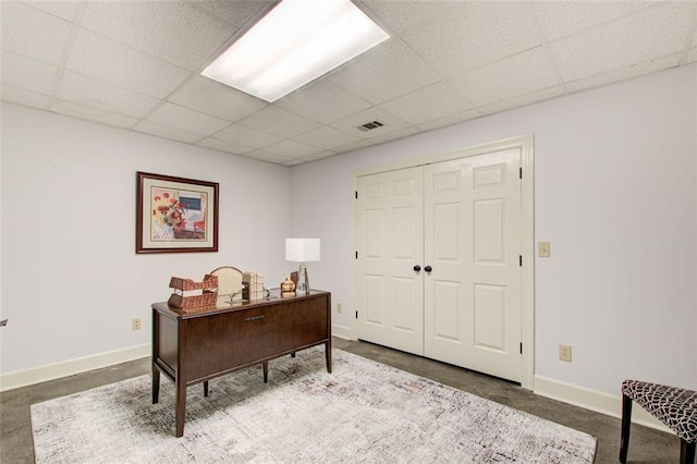 carpeted office featuring a drop ceiling