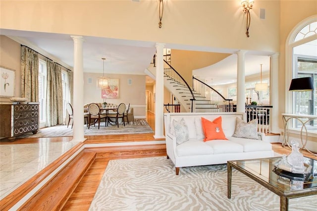 living room with wood-type flooring and ornate columns