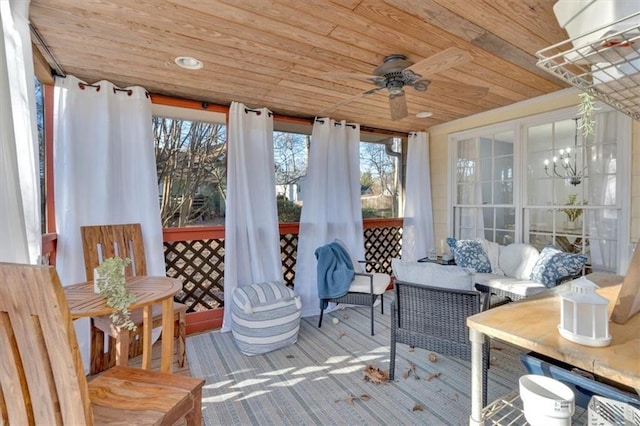 sunroom / solarium with wood ceiling and a ceiling fan