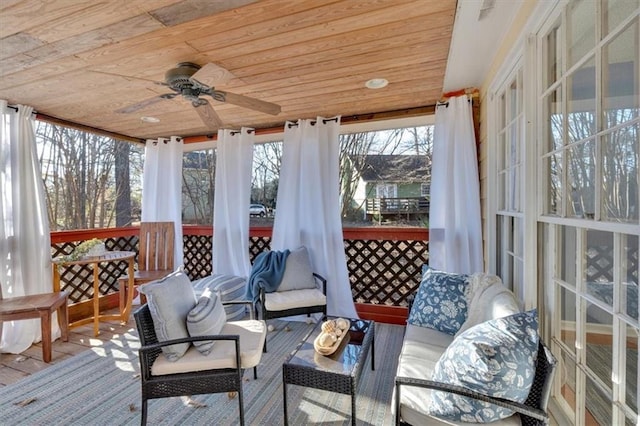 sunroom with a ceiling fan and wood ceiling