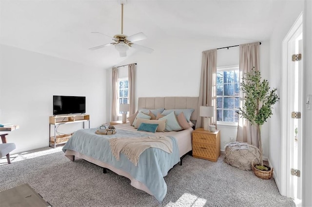 carpeted bedroom featuring vaulted ceiling and a ceiling fan