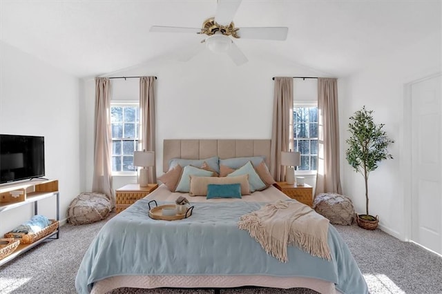 bedroom featuring carpet, multiple windows, and lofted ceiling