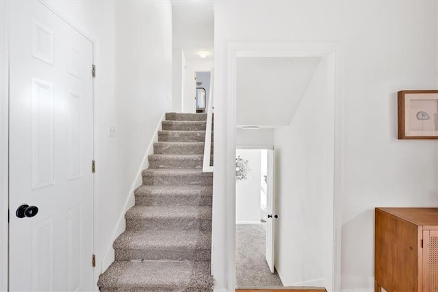 staircase with carpet and baseboards