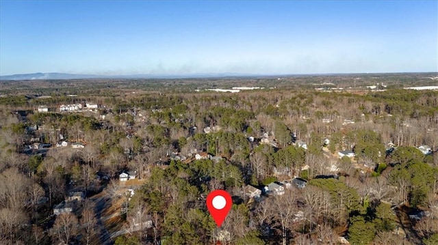 drone / aerial view featuring a view of trees