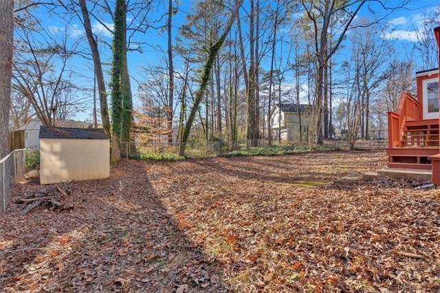 view of yard featuring an outbuilding, a storage unit, and a fenced backyard