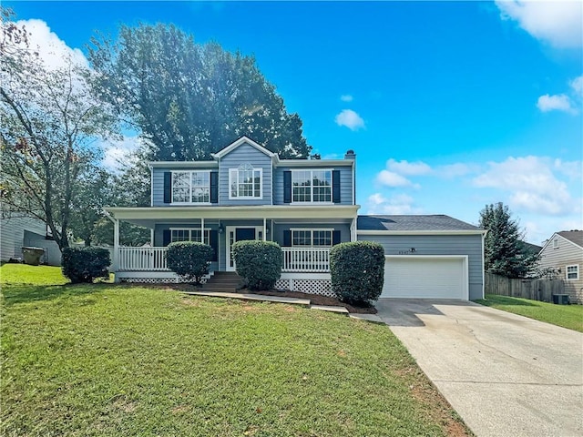 view of front of property featuring fence, a porch, a front yard, a garage, and driveway