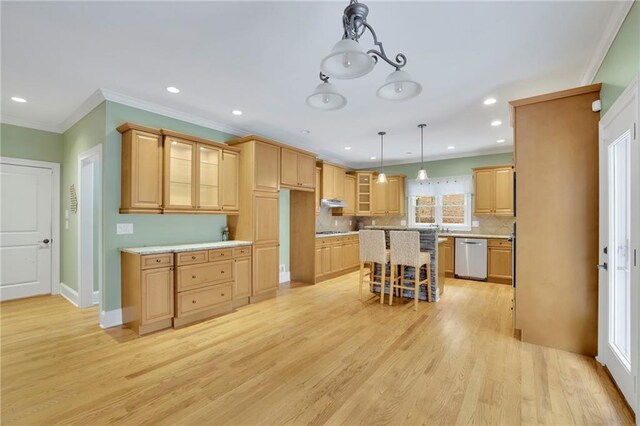 kitchen with hanging light fixtures, light hardwood / wood-style flooring, a kitchen island, and dishwasher