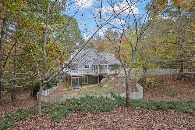 rear view of property featuring a wooden deck