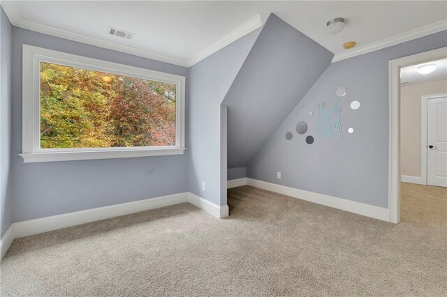 bonus room with vaulted ceiling and light carpet