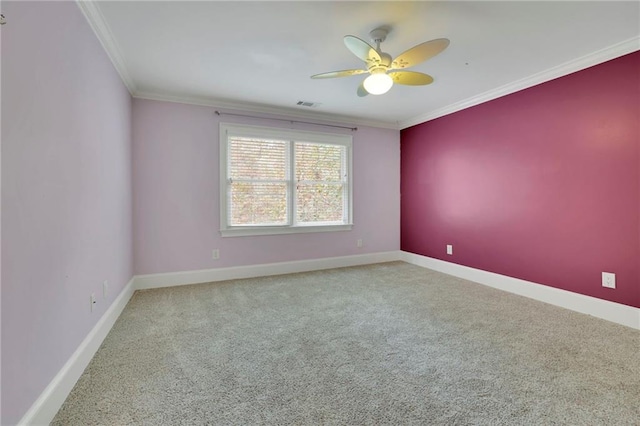 carpeted spare room featuring crown molding and ceiling fan