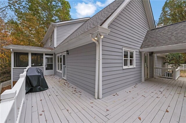 wooden terrace featuring area for grilling and a sunroom