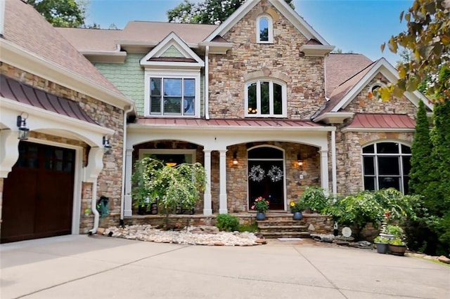 51 Mountain Ridge Dr SE, Cartersville, GA 30120 - craftsman house featuring concrete driveway, covered porch, a standing seam roof, and stone siding