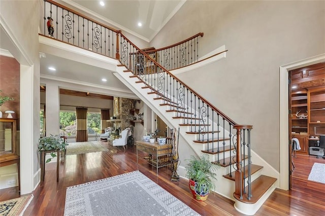 51 Mountain Ridge Dr SE, Cartersville, GA 30120 - staircase with ornamental molding, a towering ceiling, wood finished floors, and recessed lighting