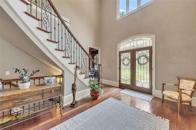 51 Mountain Ridge Dr SE, Cartersville, GA 30120 - foyer featuring french doors, stairs, wood-type flooring, and a towering ceiling