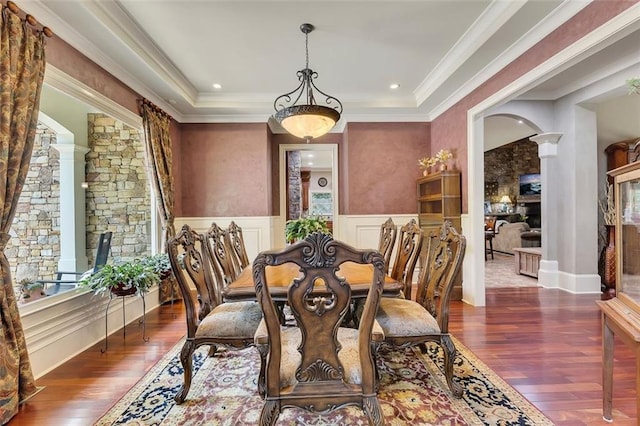 51 Mountain Ridge Dr SE, Cartersville, GA 30120 - dining space featuring decorative columns, wood finished floors, arched walkways, ornamental molding, and a wainscoted wall