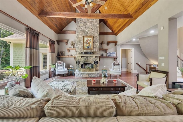51 Mountain Ridge Dr SE, Cartersville, GA 30120 - living area with a wood ceiling with exposed beams, wood finished floors, a ceiling fan, stairs, and a stone fireplace