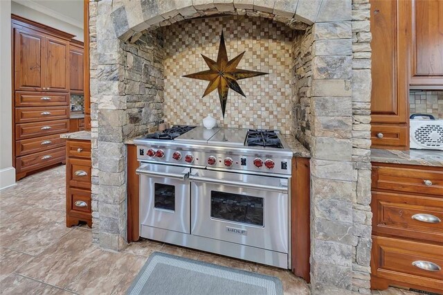 51 Mountain Ridge Dr SE, Cartersville, GA 30120 - kitchen with double oven range, crown molding, tasteful backsplash, and brown cabinets