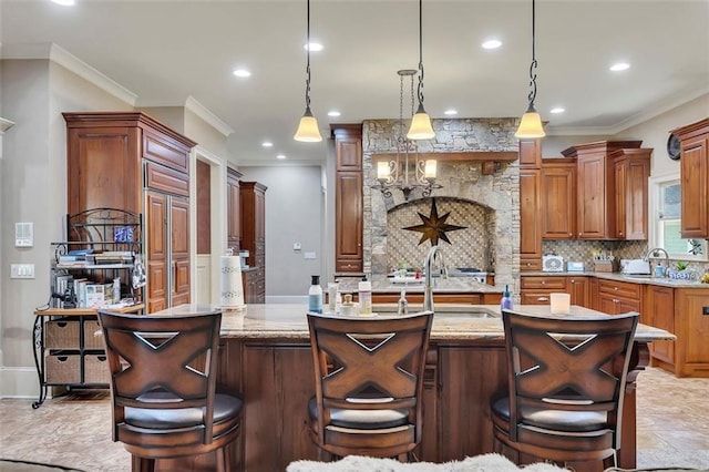 51 Mountain Ridge Dr SE, Cartersville, GA 30120 - kitchen featuring a center island with sink, decorative backsplash, recessed lighting, hanging light fixtures, and ornamental molding