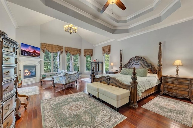 51 Mountain Ridge Dr SE, Cartersville, GA 30120 - bedroom featuring multiple windows, a raised ceiling, hardwood / wood-style flooring, a glass covered fireplace, and high vaulted ceiling