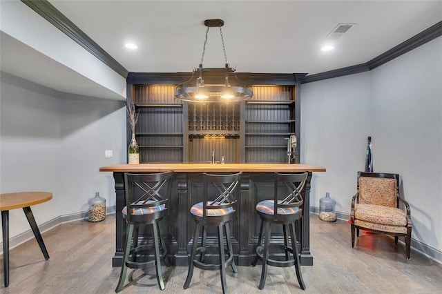 51 Mountain Ridge Dr SE, Cartersville, GA 30120 - indoor bar featuring crown molding, wood finished floors, decorative light fixtures, and recessed lighting