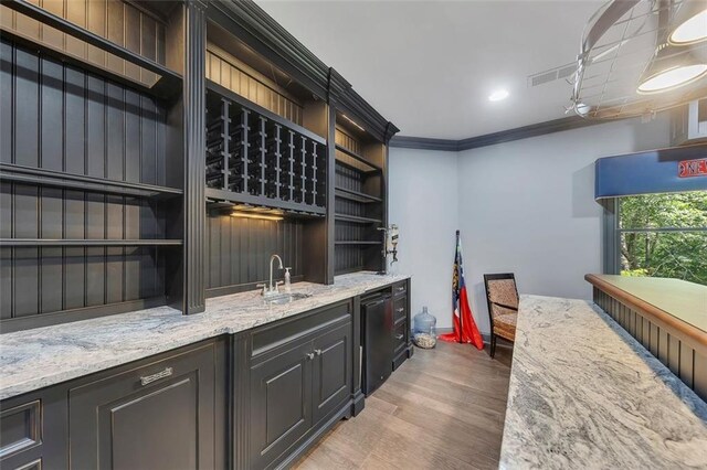 51 Mountain Ridge Dr SE, Cartersville, GA 30120 - wine cellar with ornamental molding, bar with sink, and light wood finished floors