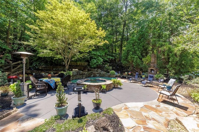 51 Mountain Ridge Dr SE, Cartersville, GA 30120 - view of patio with an outdoor stone fireplace and an in-ground hot tub