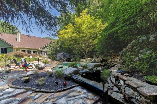 51 Mountain Ridge Dr SE, Cartersville, GA 30120 - view of yard with a storage unit and a patio