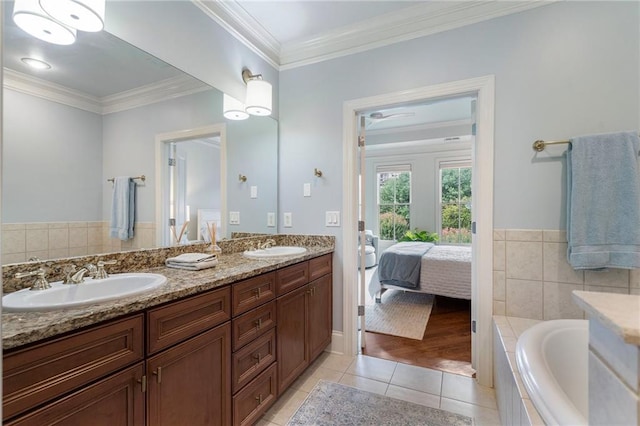 bathroom with vanity, crown molding, tile patterned floors, and a relaxing tiled tub