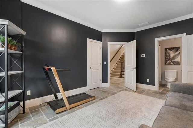 workout area featuring ornamental molding