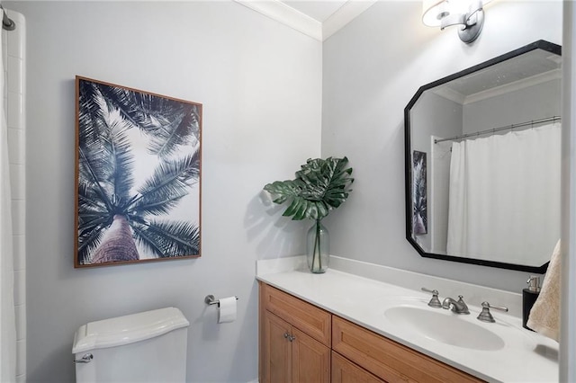 bathroom with ornamental molding, vanity, and toilet