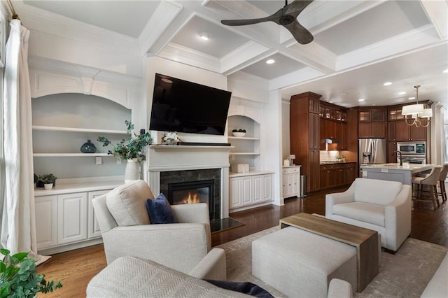 living room featuring coffered ceiling, beam ceiling, a high end fireplace, and dark hardwood / wood-style floors