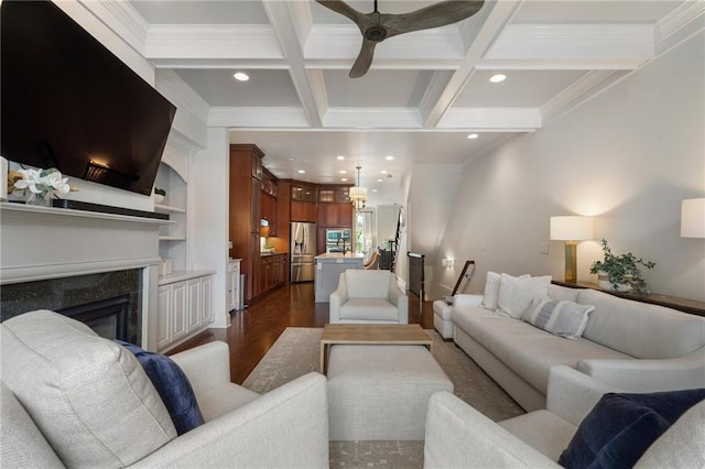 living room with dark hardwood / wood-style floors, a fireplace, beamed ceiling, ornamental molding, and coffered ceiling