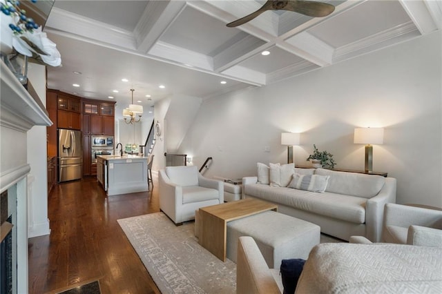 living room featuring sink, beam ceiling, coffered ceiling, ornamental molding, and dark hardwood / wood-style flooring