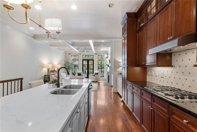 kitchen with beamed ceiling, coffered ceiling, sink, and pendant lighting