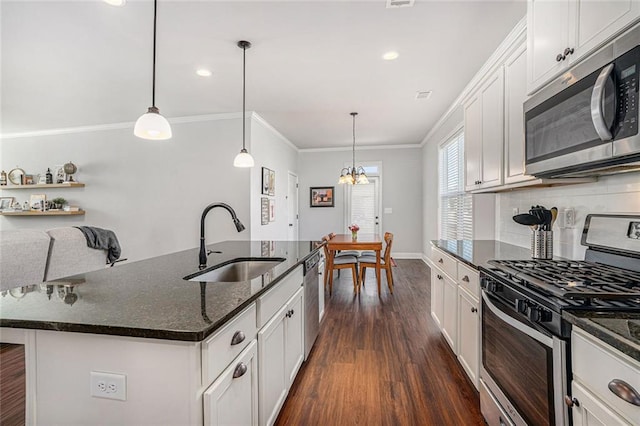 kitchen featuring a sink, ornamental molding, appliances with stainless steel finishes, backsplash, and dark wood finished floors