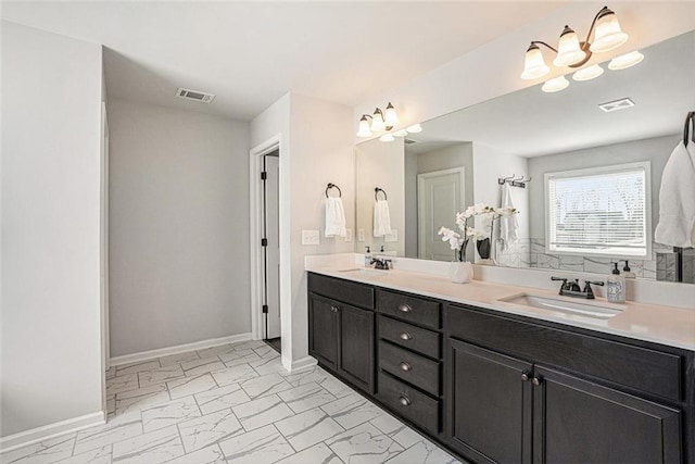 full bathroom with double vanity, marble finish floor, visible vents, and a sink