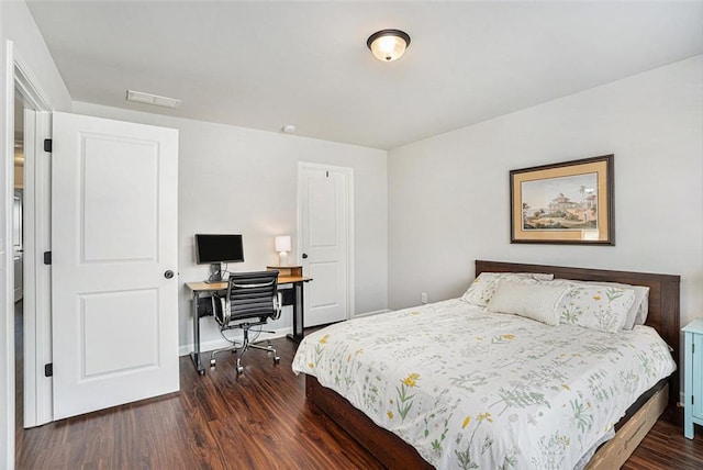 bedroom with dark wood-style flooring and baseboards