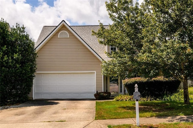 view of front of property featuring a garage, concrete driveway, and roof with shingles