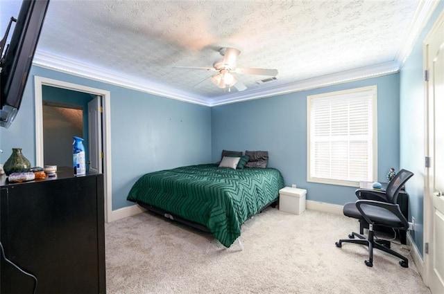 carpeted bedroom featuring visible vents, crown molding, baseboards, a textured ceiling, and a ceiling fan