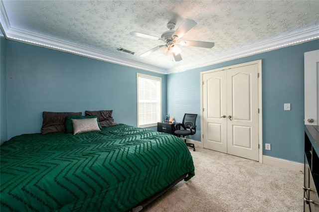 carpeted bedroom featuring visible vents, crown molding, baseboards, a textured ceiling, and a ceiling fan