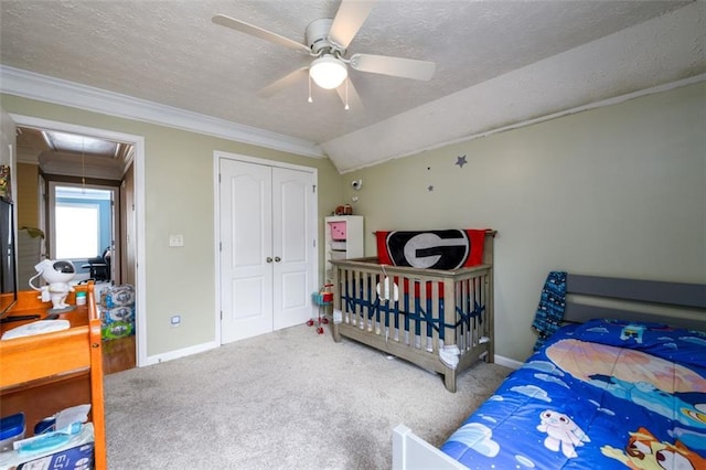 bedroom featuring attic access, carpet, a closet, and a textured ceiling