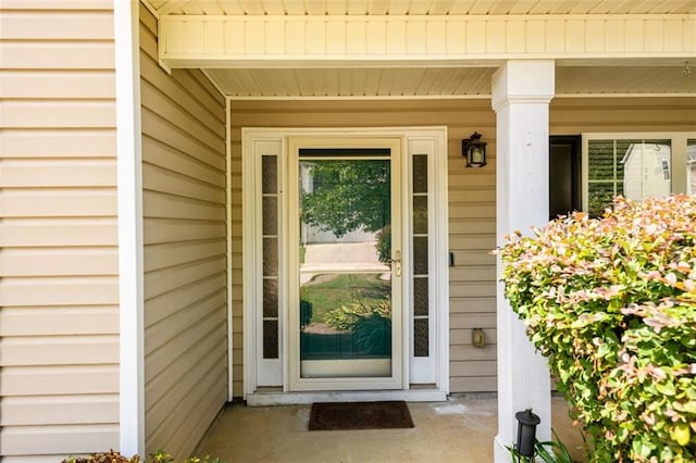 view of exterior entry with covered porch