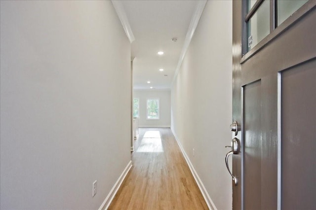 hall featuring ornamental molding, recessed lighting, light wood-style floors, and baseboards