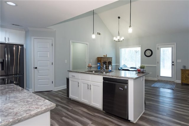 kitchen with white cabinetry, hanging light fixtures, a kitchen island with sink, light stone counters, and black appliances