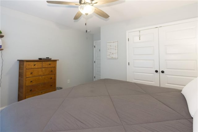 bedroom featuring ceiling fan and a closet