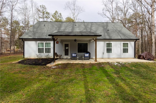 rear view of house featuring a yard, a patio area, and ceiling fan