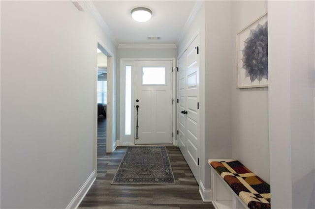 doorway featuring crown molding and dark wood-type flooring