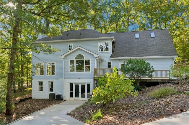 back of house featuring french doors, a deck, and central air condition unit